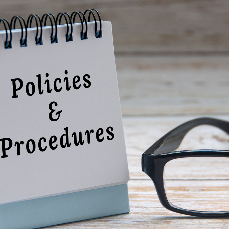 A flip pad with policies and procedures written on it plus some glasses